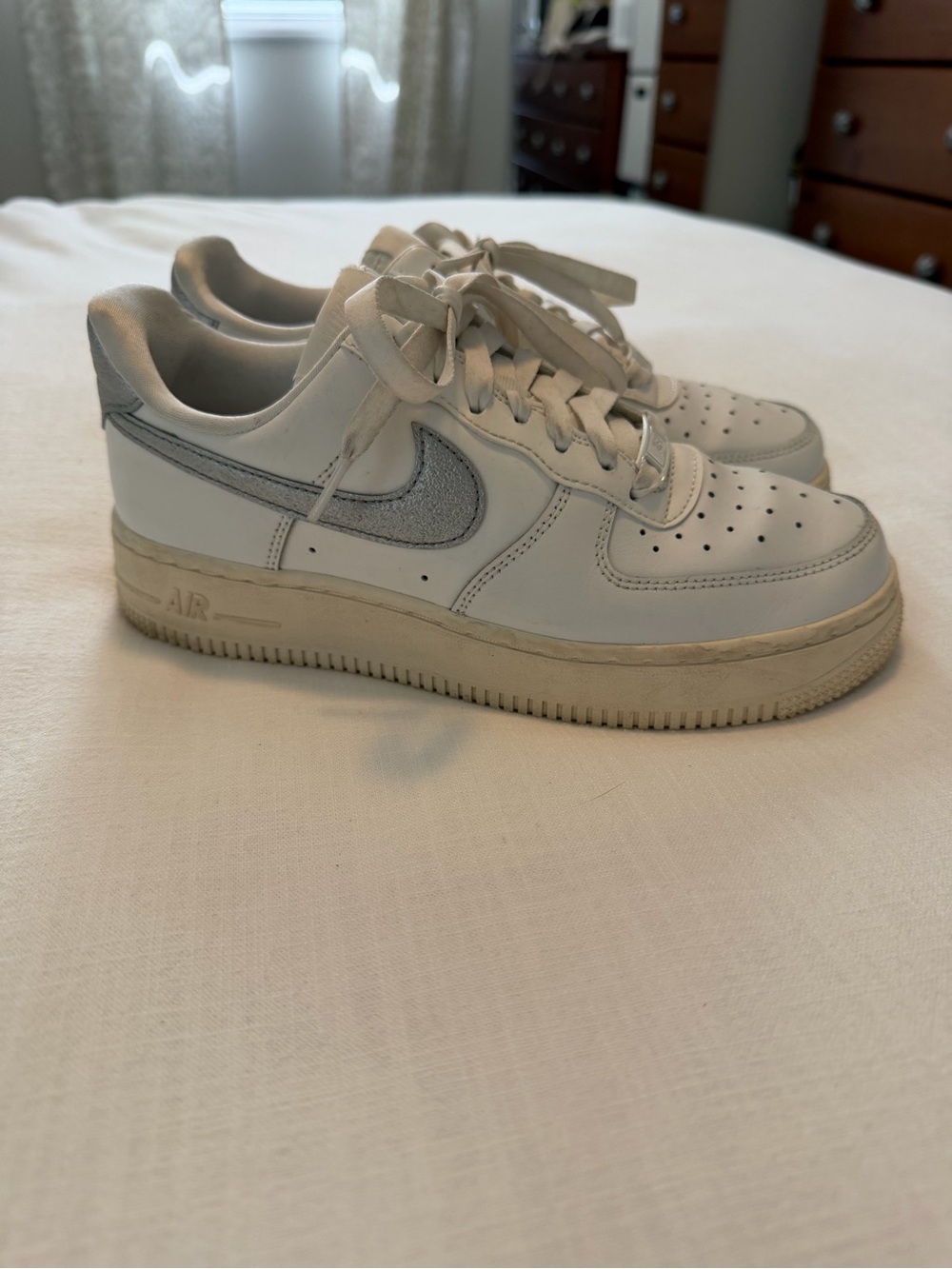 Nike White Low-Top Sneakers with Silver Metallic Swoosh